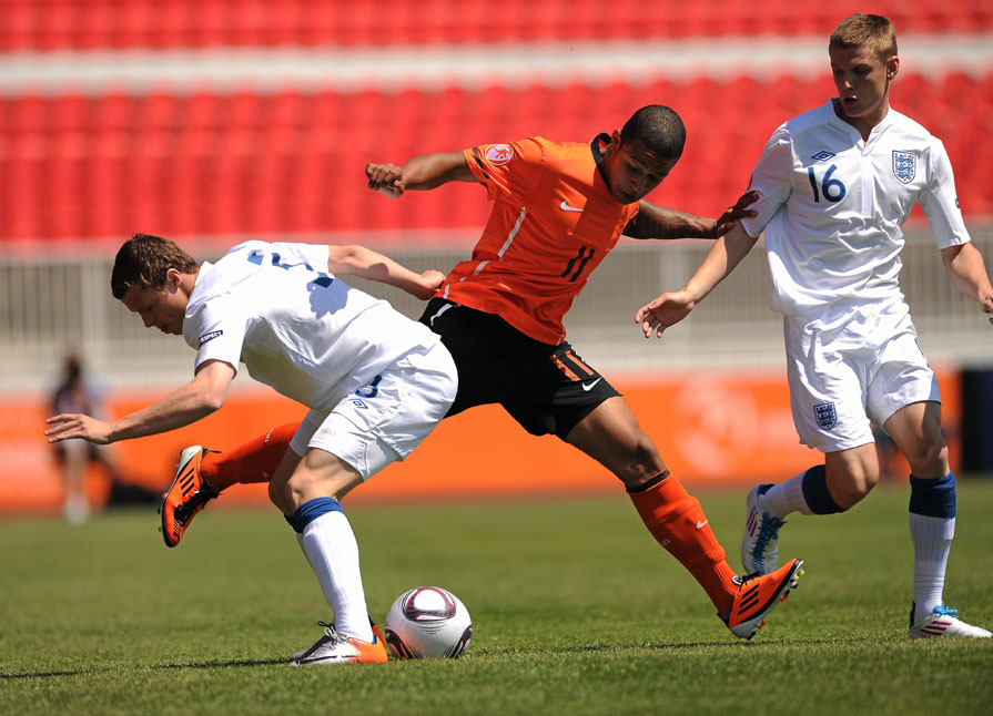 England's Brad Smith and Holland's Memphis Depay battle for possession in the 2011 UEFA European U17 Championship semi-final.